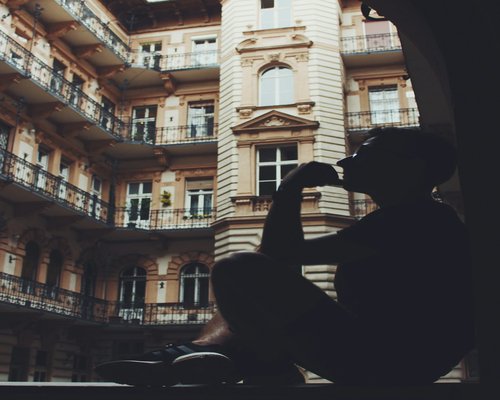 Man drinking coffee and having a calm morning routine by the window in Budapest