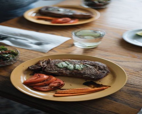 Simple home cooked lunch on a wooden table with a glass of water