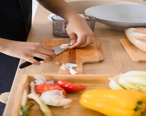 Fresh ingredients like vegetables and bread on a kitchen counter